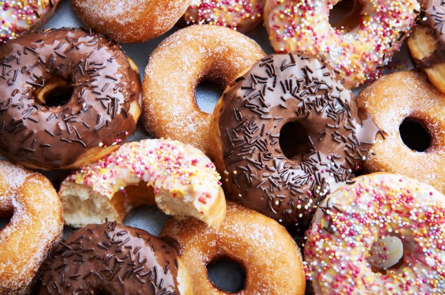 Ring doughnuts covered in icing and sprinkes