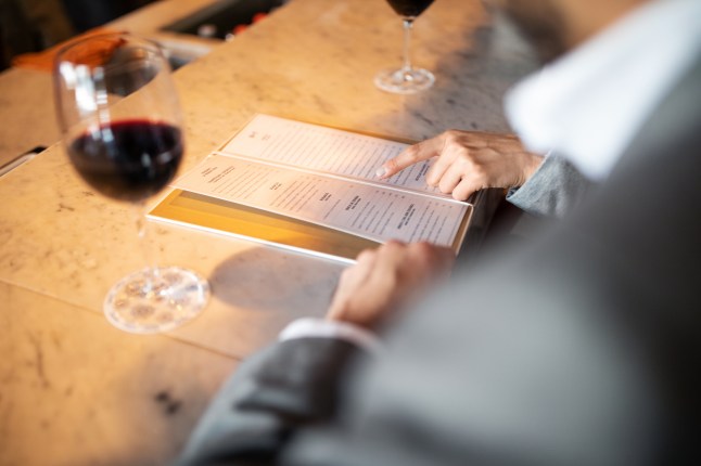 People looking at a wine list