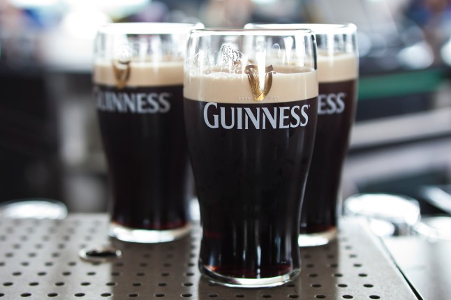 Pints of Guinness at a bar.