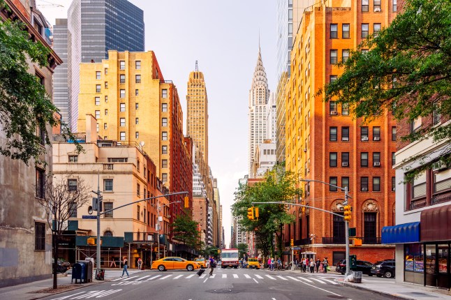 Street in Midtown Manhattan with Chrysler Building on a sunny summer day, New York City, USA