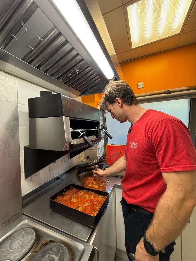 Ben cooking meatballs at work