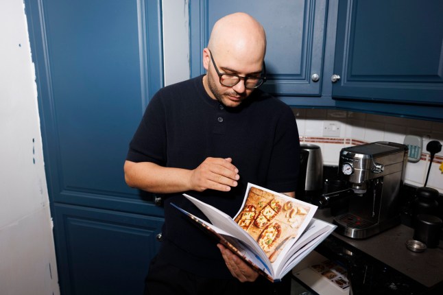 Michele Pascarella in his kitchen. Pictured: Michele???s cook book. (C) Belinda Jiao 07598931257 jiao.bilin@gmail.com