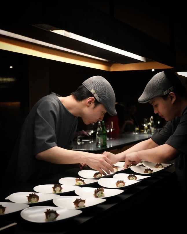 Atomix NYC, image shows restaurant staff plating up food