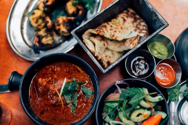 Directly above shot of assorted authentic Indian food in plates on table